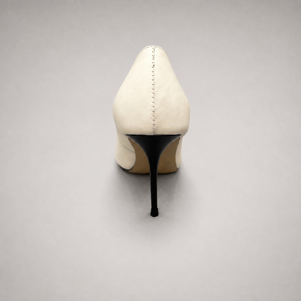 White pump rear view showing a pointed toe