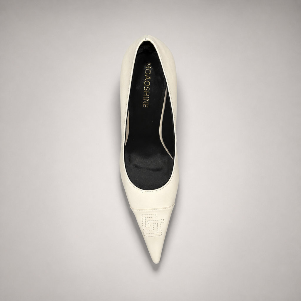 White pump top view showing a pointed toe