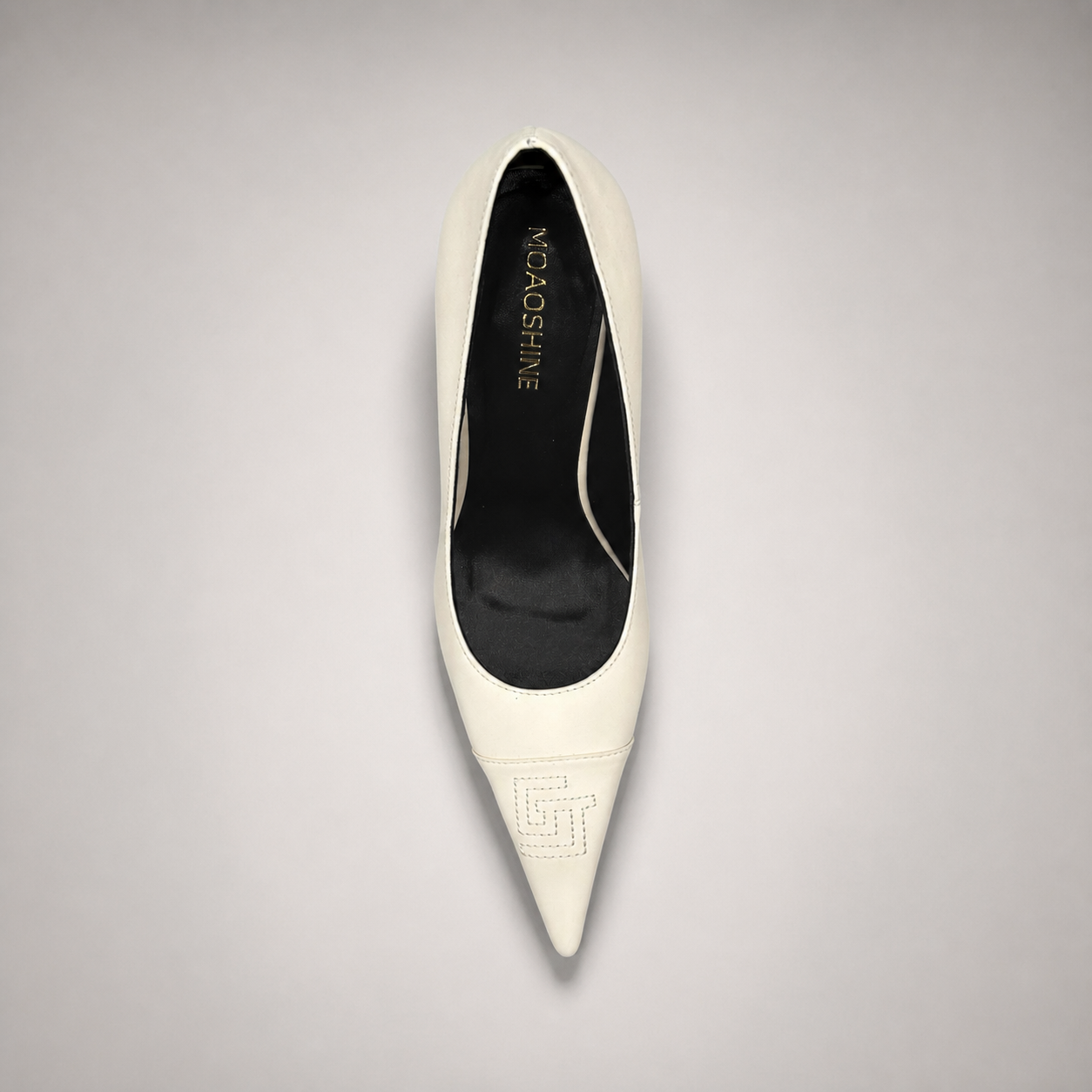 White pump top view showing a pointed toe
