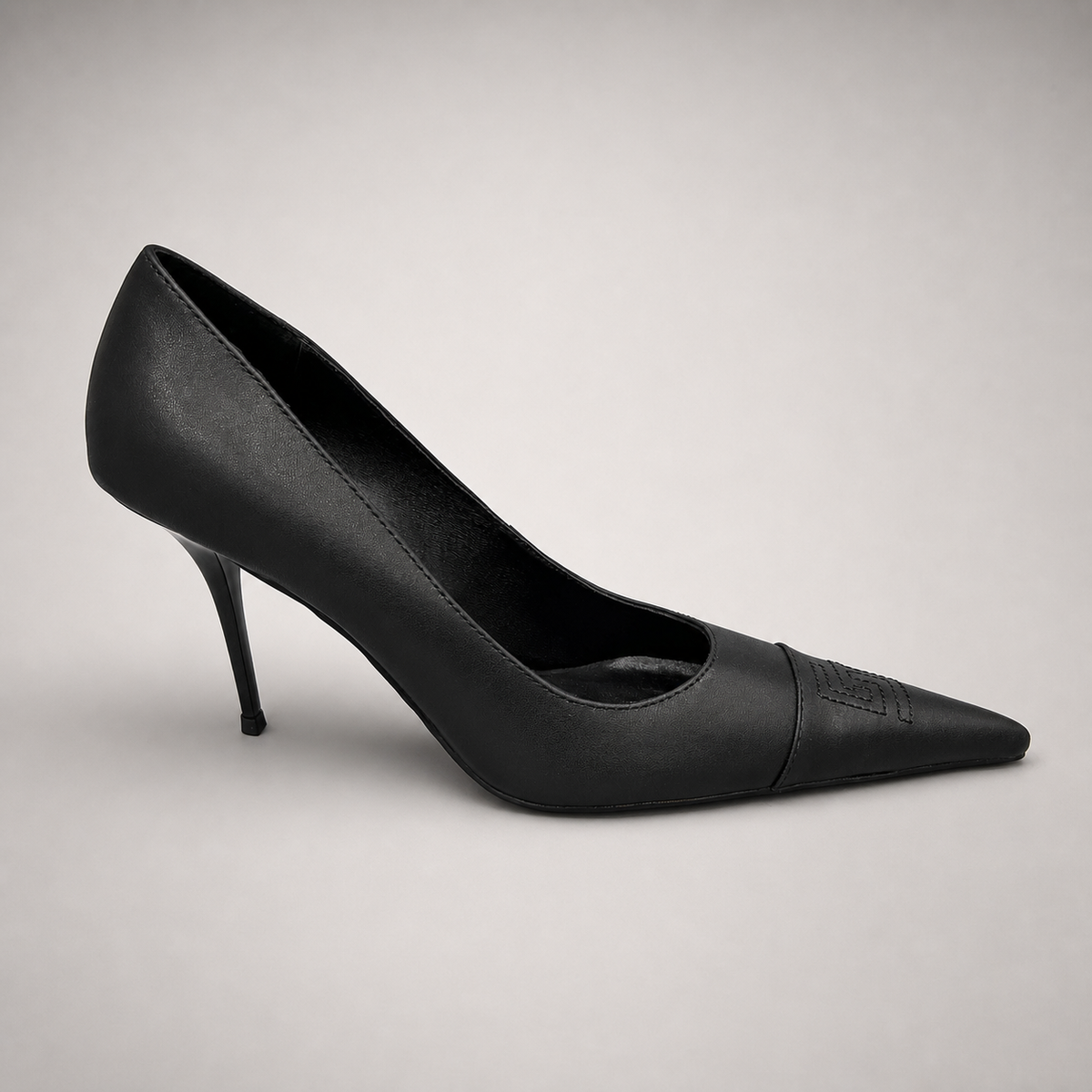 Black pump pair three-quarter view showing a pointed toe