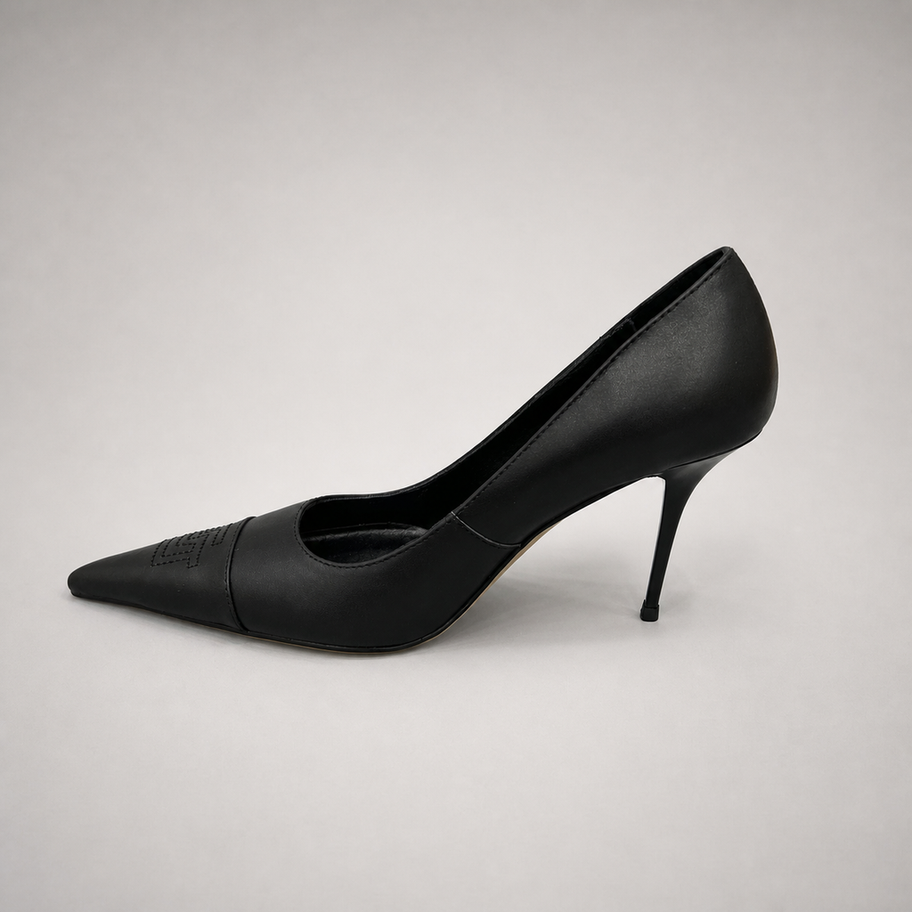Black pump opposite side profile showing a pointed toe