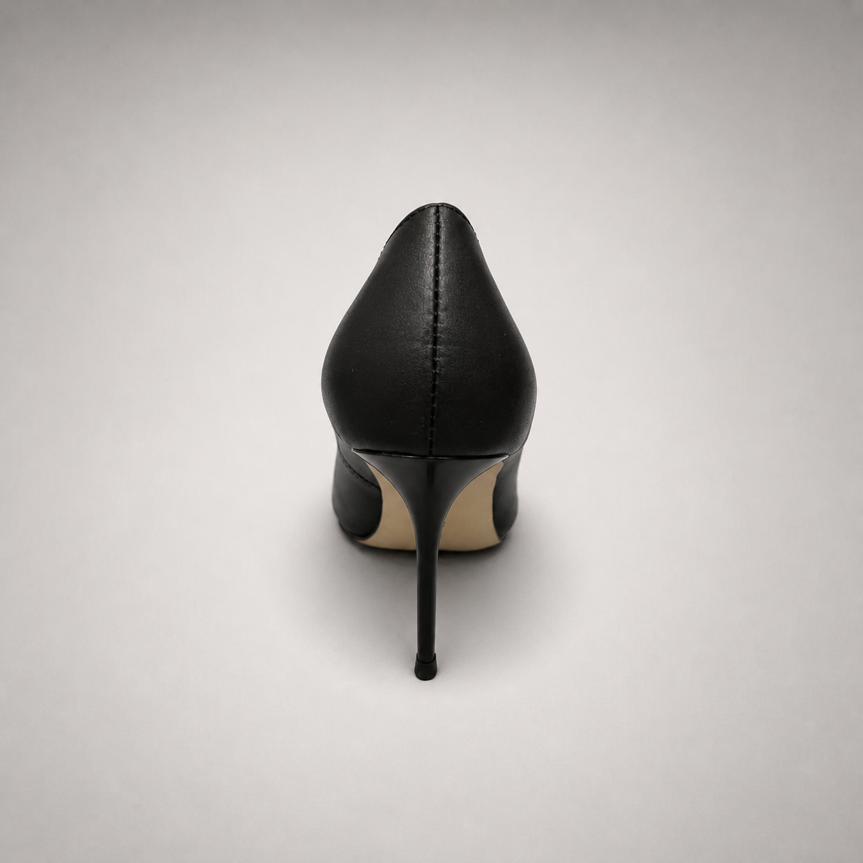 Black pump rear view showing a pointed toe
