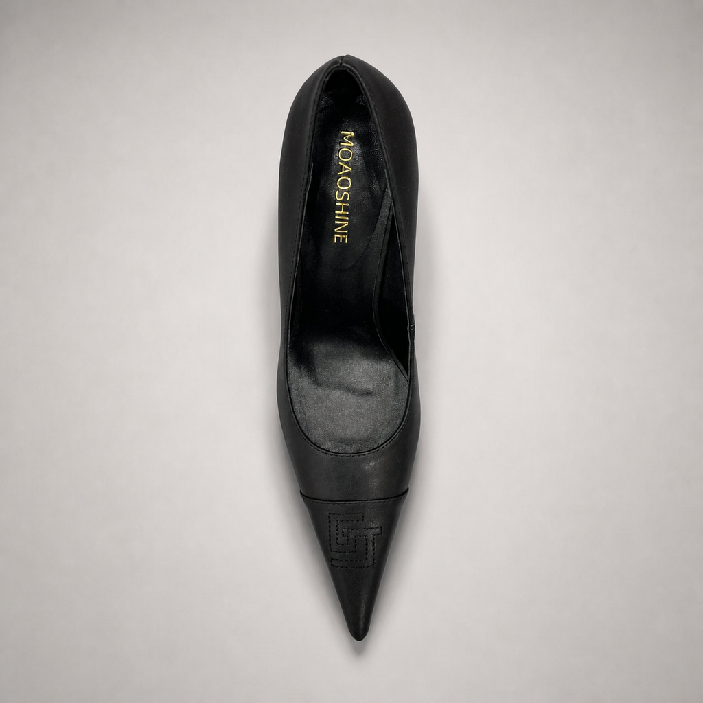 Black pump top view showing a pointed toe