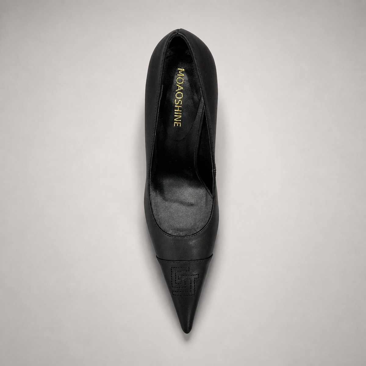 Black pump top view showing a pointed toe