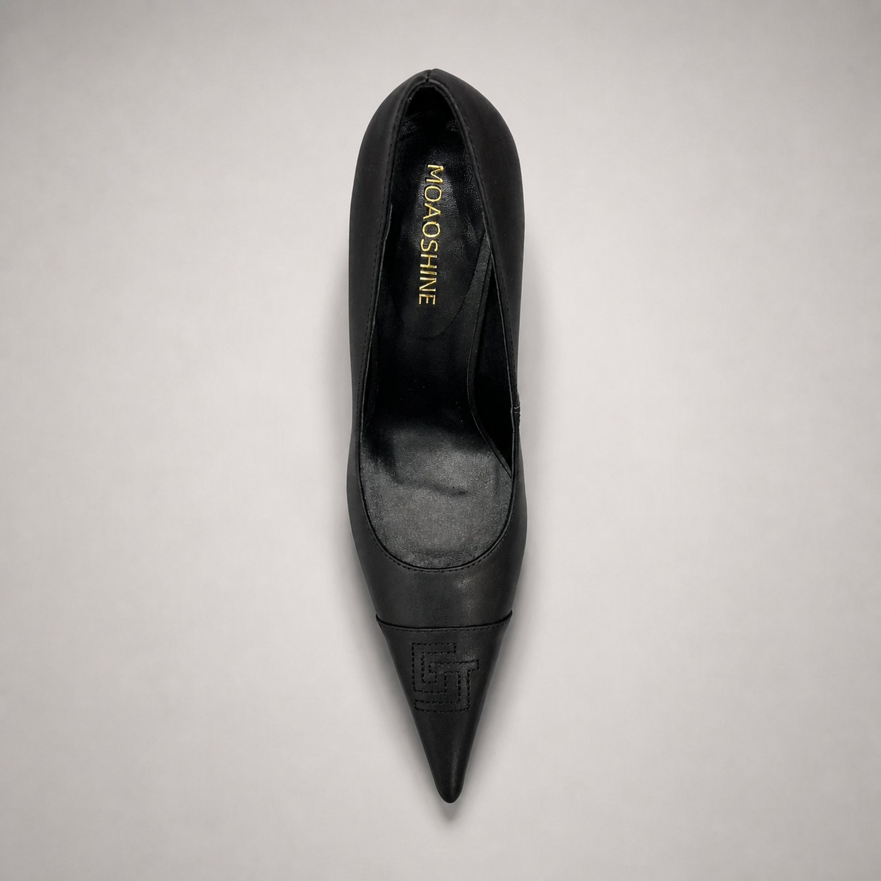 Black pump top view showing a pointed toe