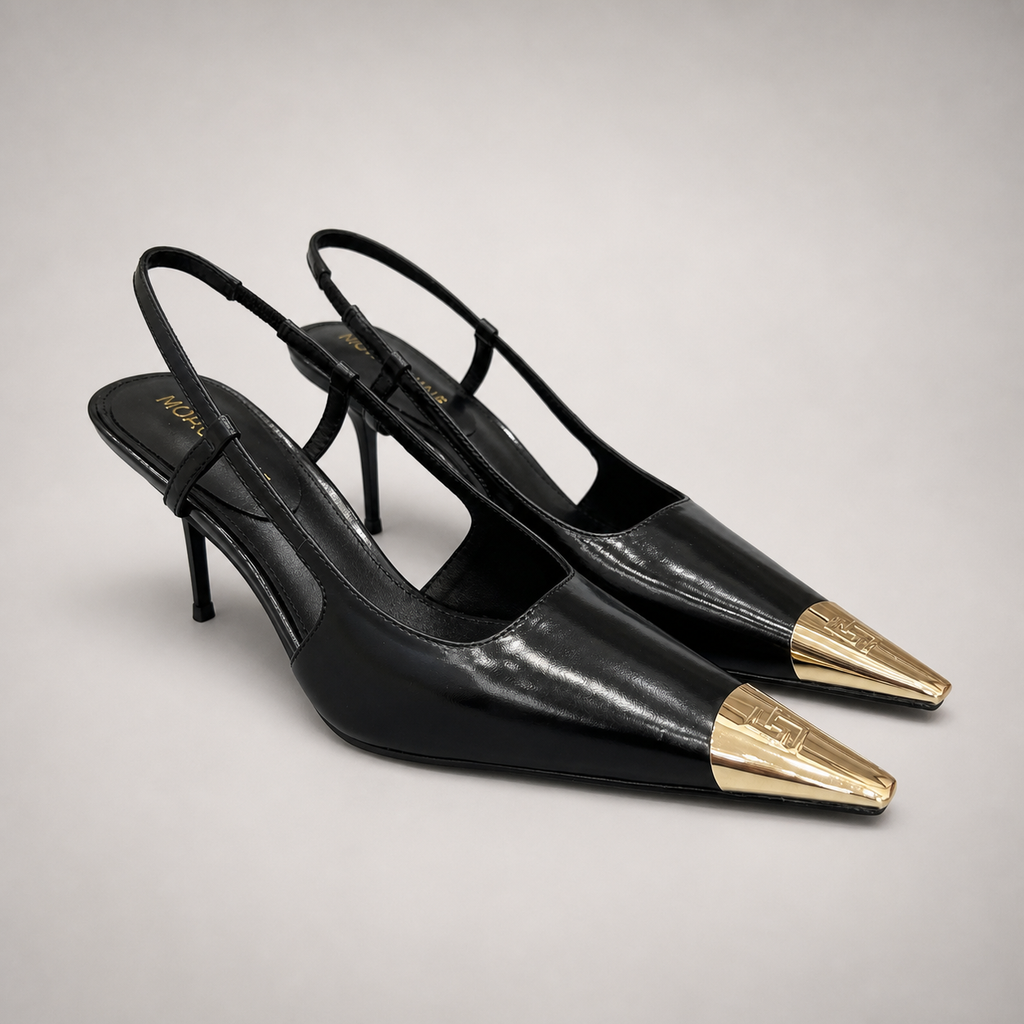 Black slingback pump pair three-quarter view showing a pointed toe, slingback strap, and metal toe cap