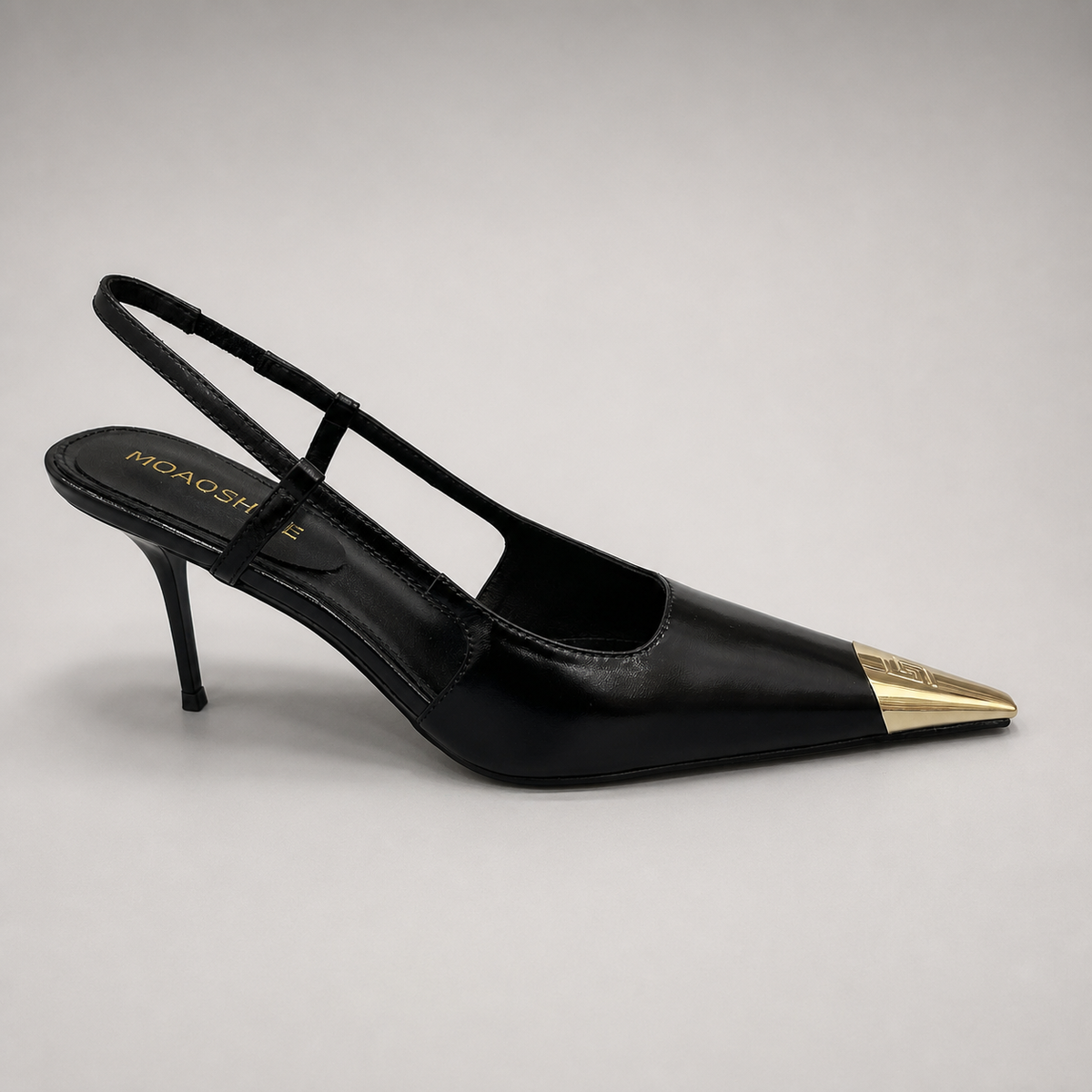 Black slingback pump side profile showing a pointed toe, slingback strap, and metal toe cap