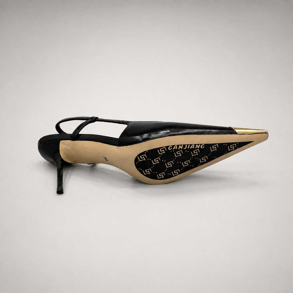 Black slingback pump top view showing a pointed toe, slingback strap, and metal toe cap
