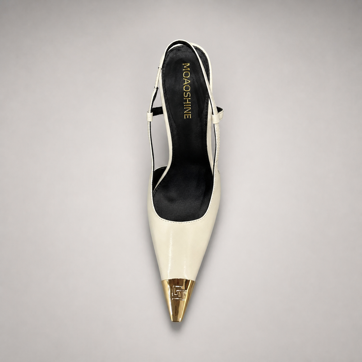 White slingback pump top view showing a pointed toe, slingback strap, and metal toe cap