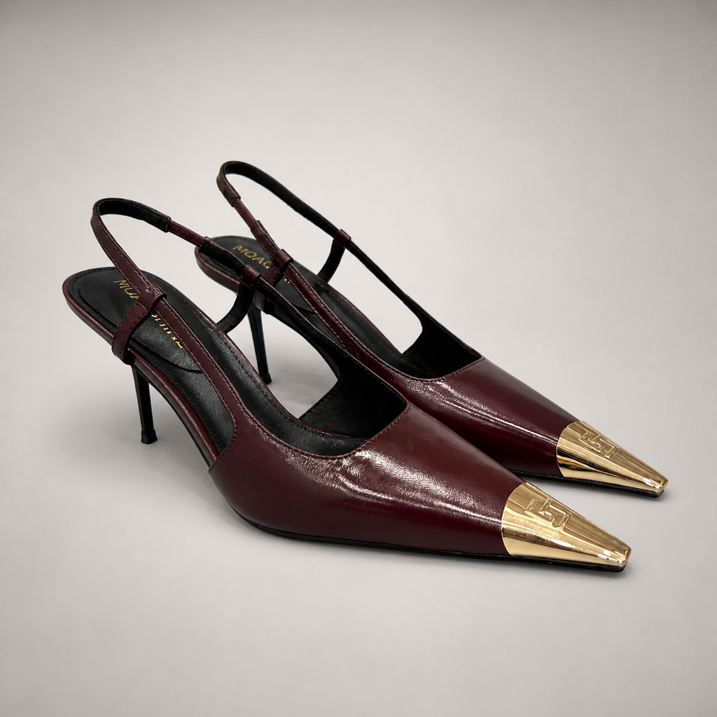 Burgundy slingback pump pair three-quarter view showing a pointed toe, slingback strap, and metal toe cap
