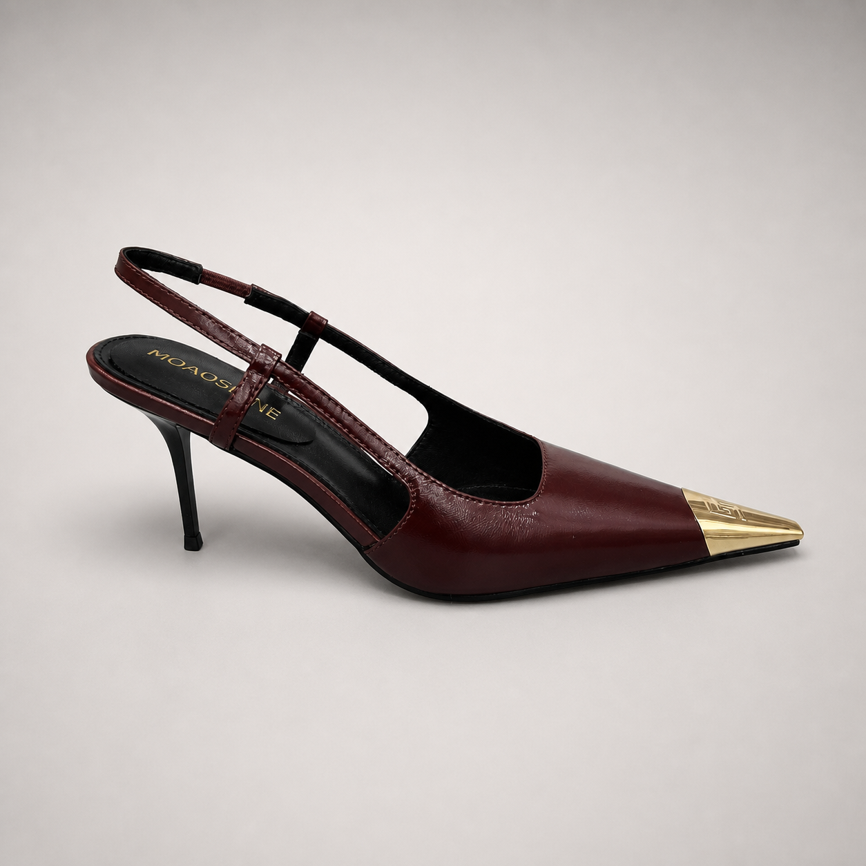 Burgundy slingback pump side profile showing a pointed toe, slingback strap, and metal toe cap