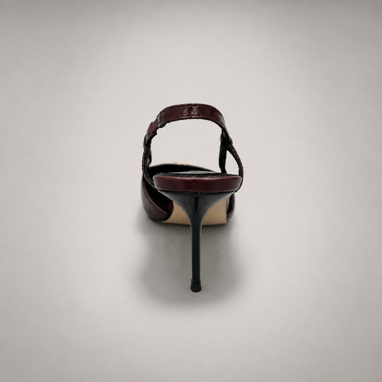 Burgundy slingback pump rear view showing a pointed toe, slingback strap, and metal toe cap