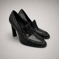 Black high-heeled loafer pair three-quarter view showing a loafer-inspired vamp and block heel