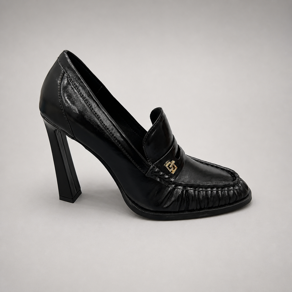 Black high-heeled loafer side profile showing a loafer-inspired vamp and block heel