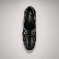 Black high-heeled loafer rear view showing a loafer-inspired vamp and block heel