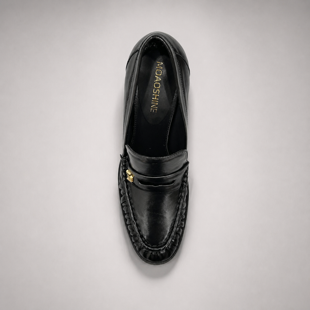 Black high-heeled loafer rear view showing a loafer-inspired vamp and block heel
