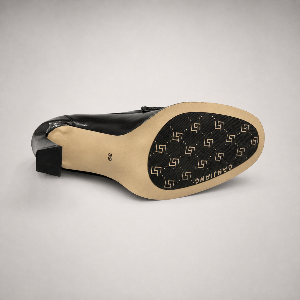 Black high-heeled loafer top view showing a loafer-inspired vamp and block heel