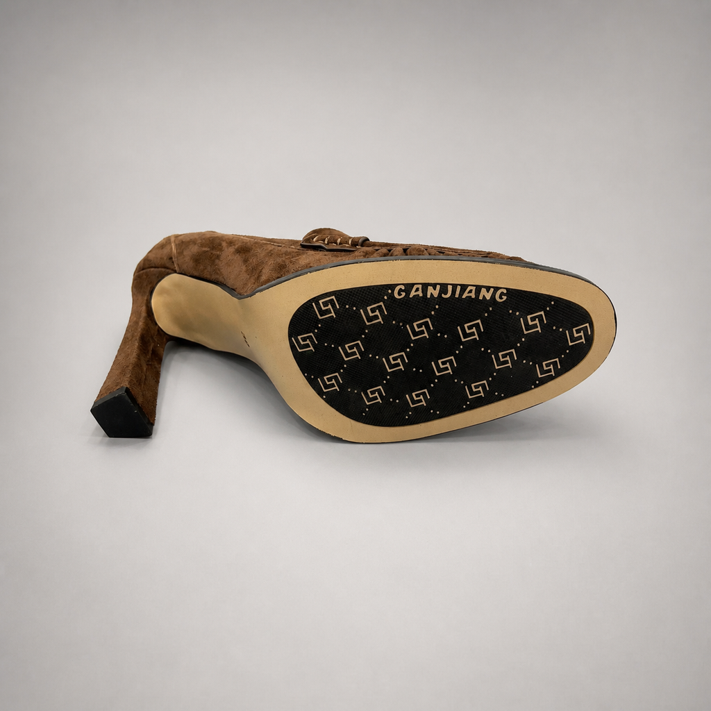 Brown high-heeled loafer outsole view showing the cow leather outsole