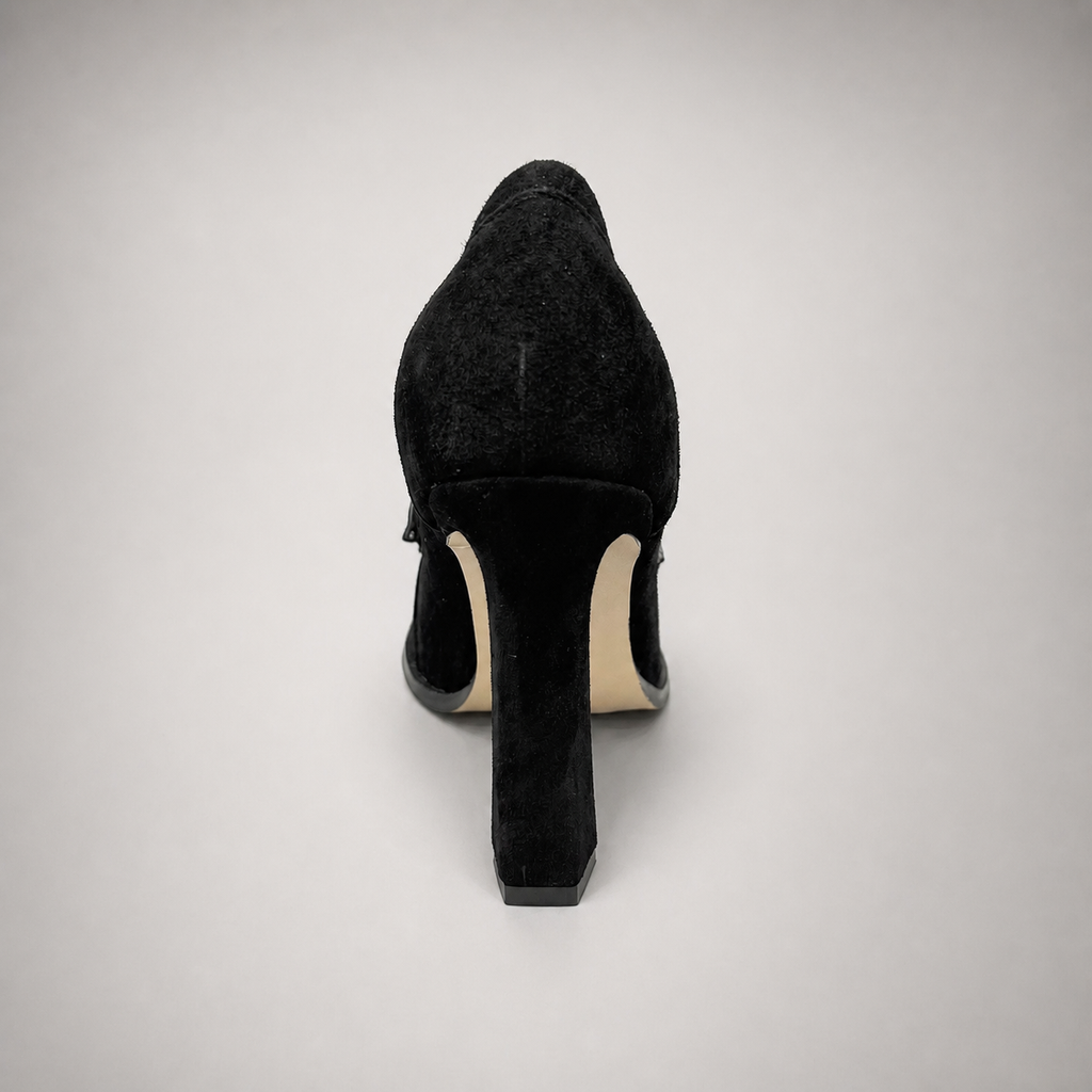 Black high-heeled loafer rear view showing a loafer-inspired vamp and block heel