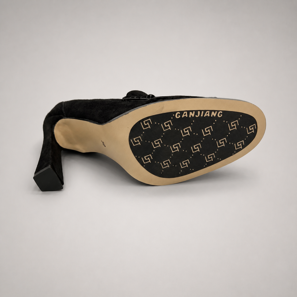 Black high-heeled loafer outsole view showing the cow leather outsole