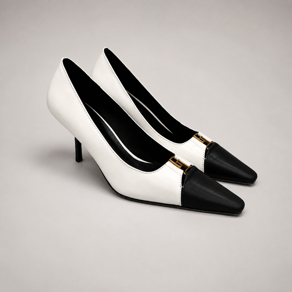 White pump pair three-quarter view showing a square toe, slingback strap, and metal accent