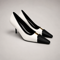White pump pair three-quarter view showing a square toe, slingback strap, and metal accent