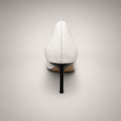 White pump rear view showing a square toe, slingback strap, and metal accent