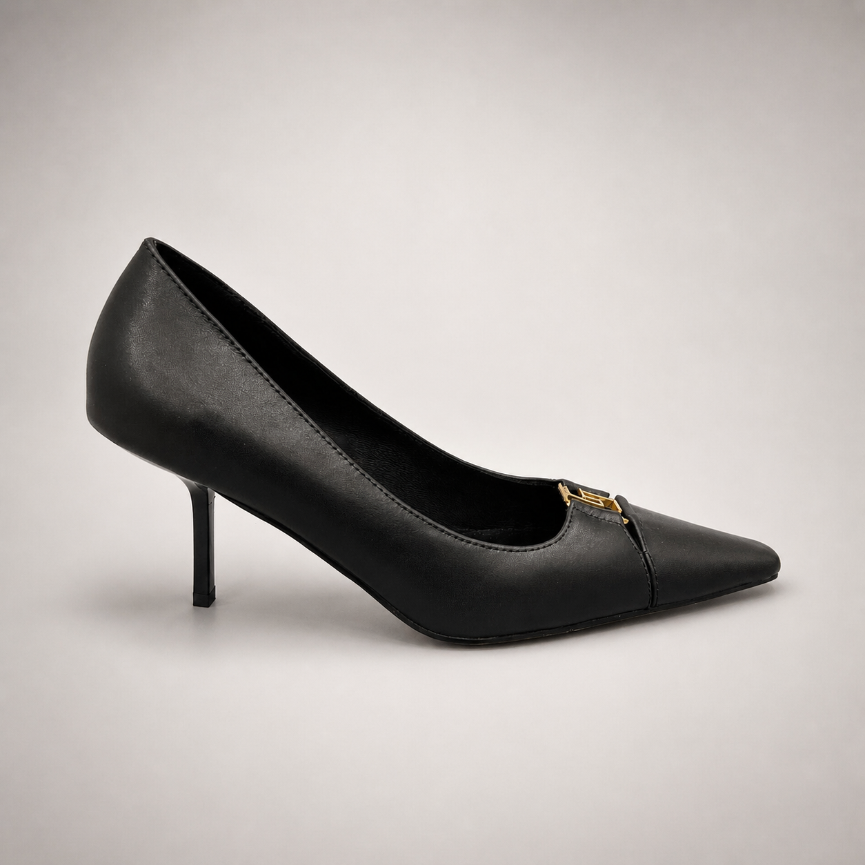 Black pump side profile showing a square toe, slingback strap, and metal accent