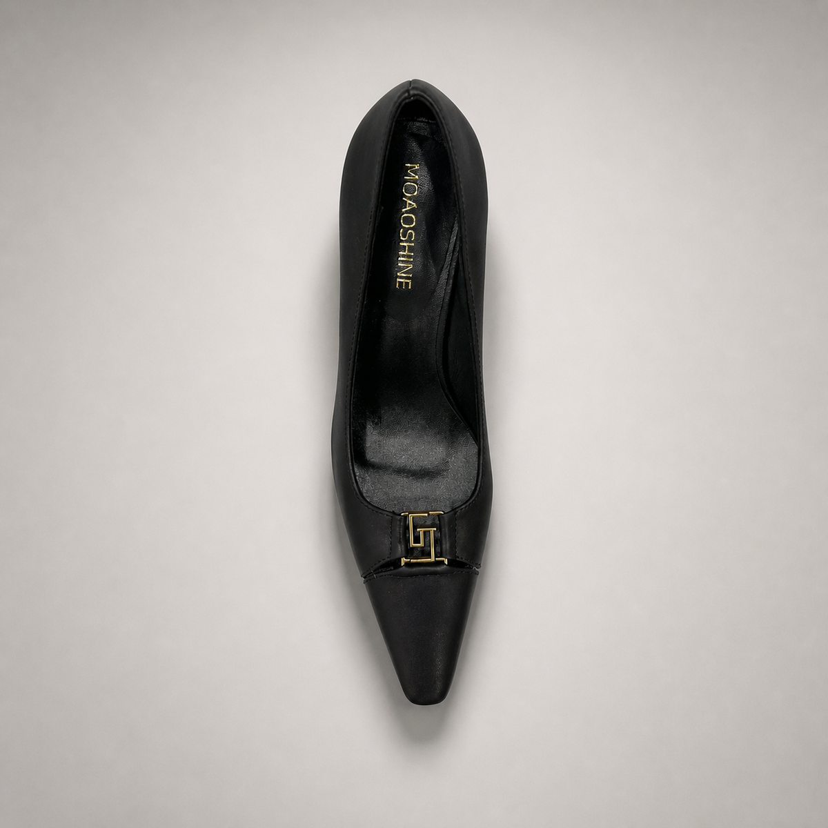 Black pump top view showing a square toe, slingback strap, and metal accent