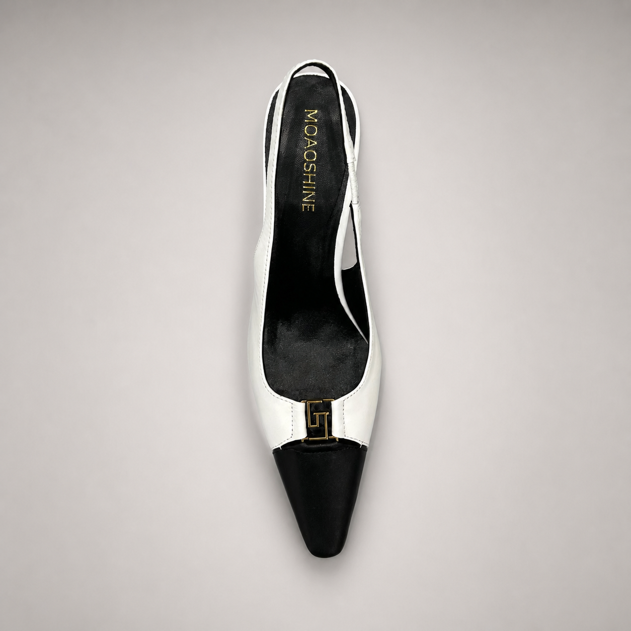 White slingback pump top view showing a square toe, slingback strap, and metal accent