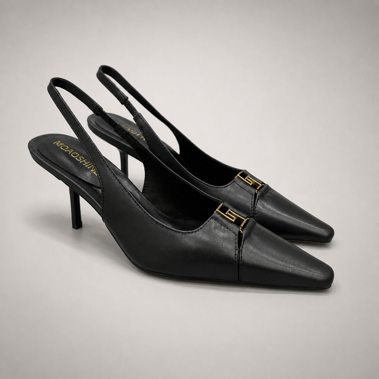 Black slingback pump pair three-quarter view showing a square toe, slingback strap, and metal accent