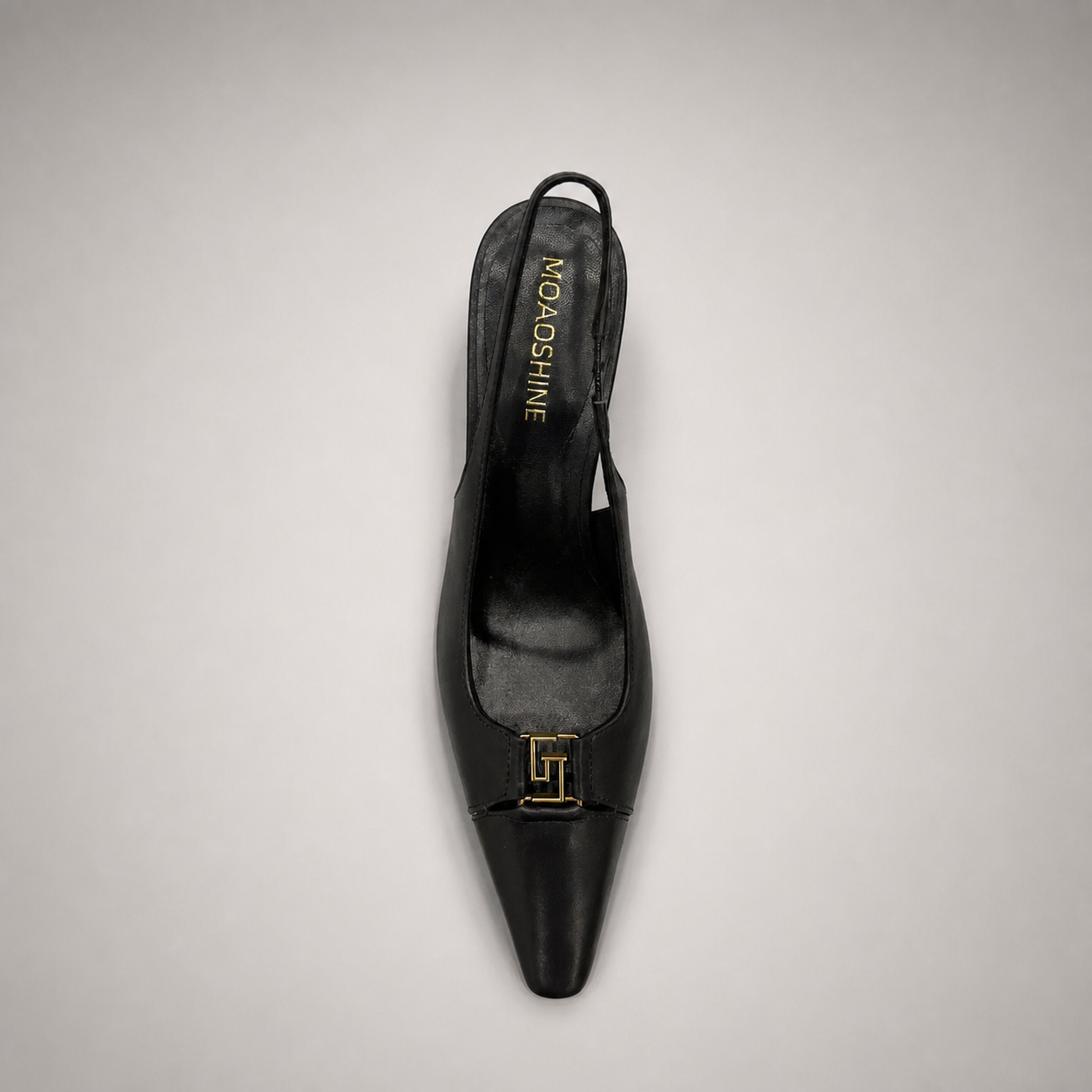 Black slingback pump top view showing a square toe, slingback strap, and metal accent