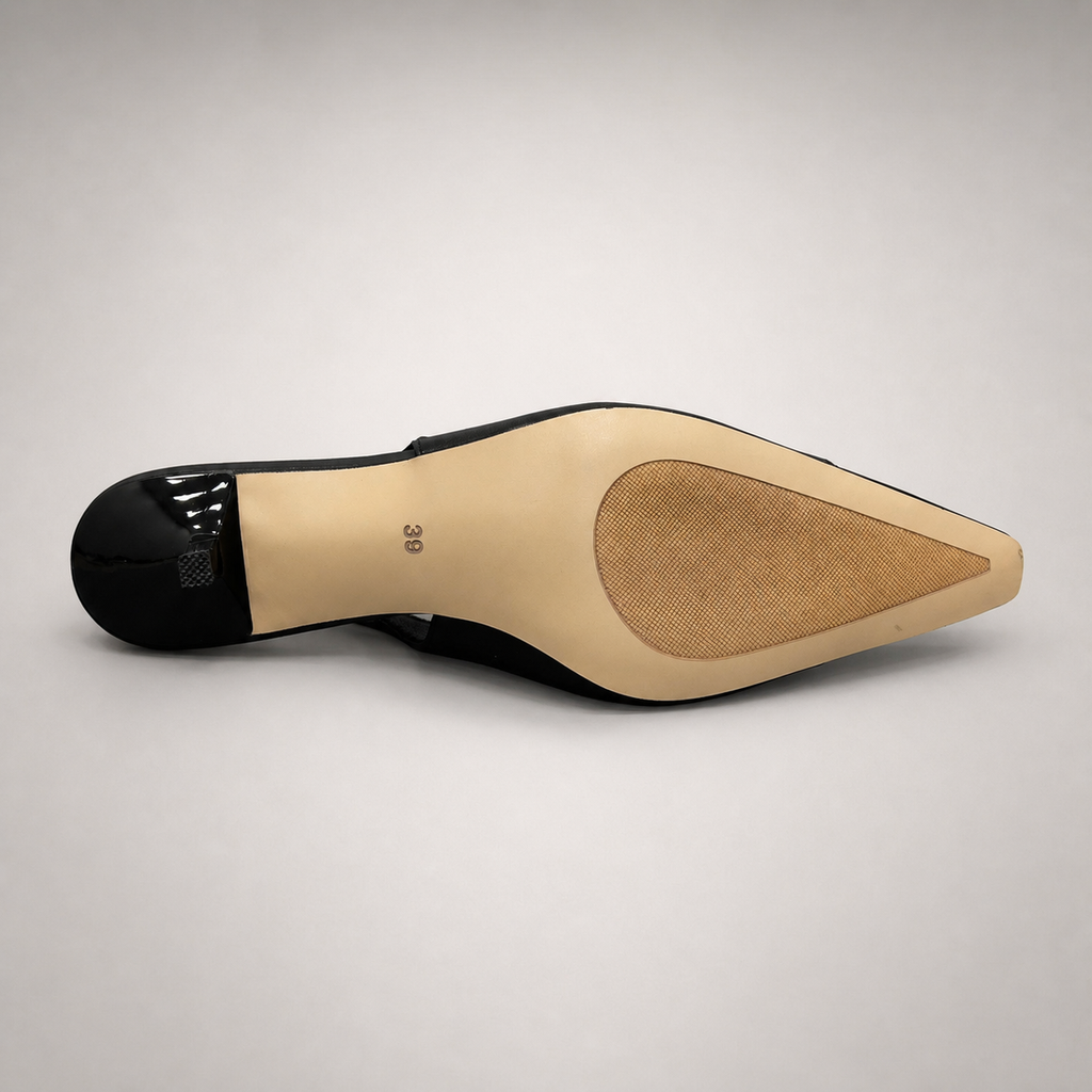 Black slingback pump outsole view showing the cow leather outsole
