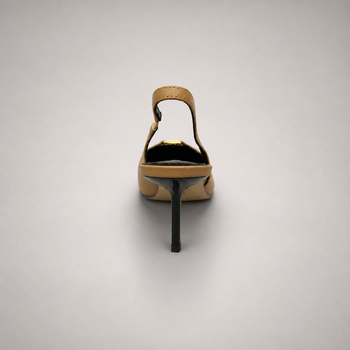 Tan slingback pump rear view showing a square toe, slingback strap, and metal accent