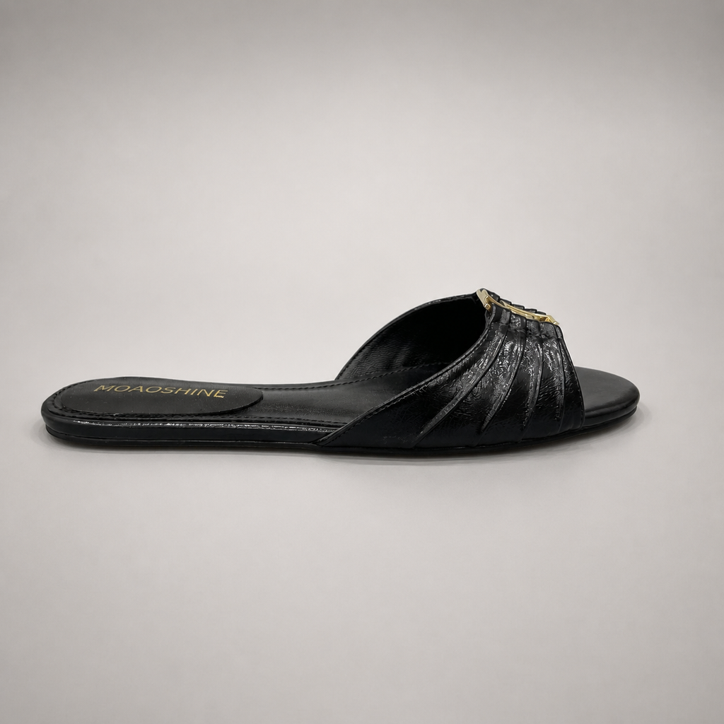 Black slide sandal side profile showing a pleated forefoot strap