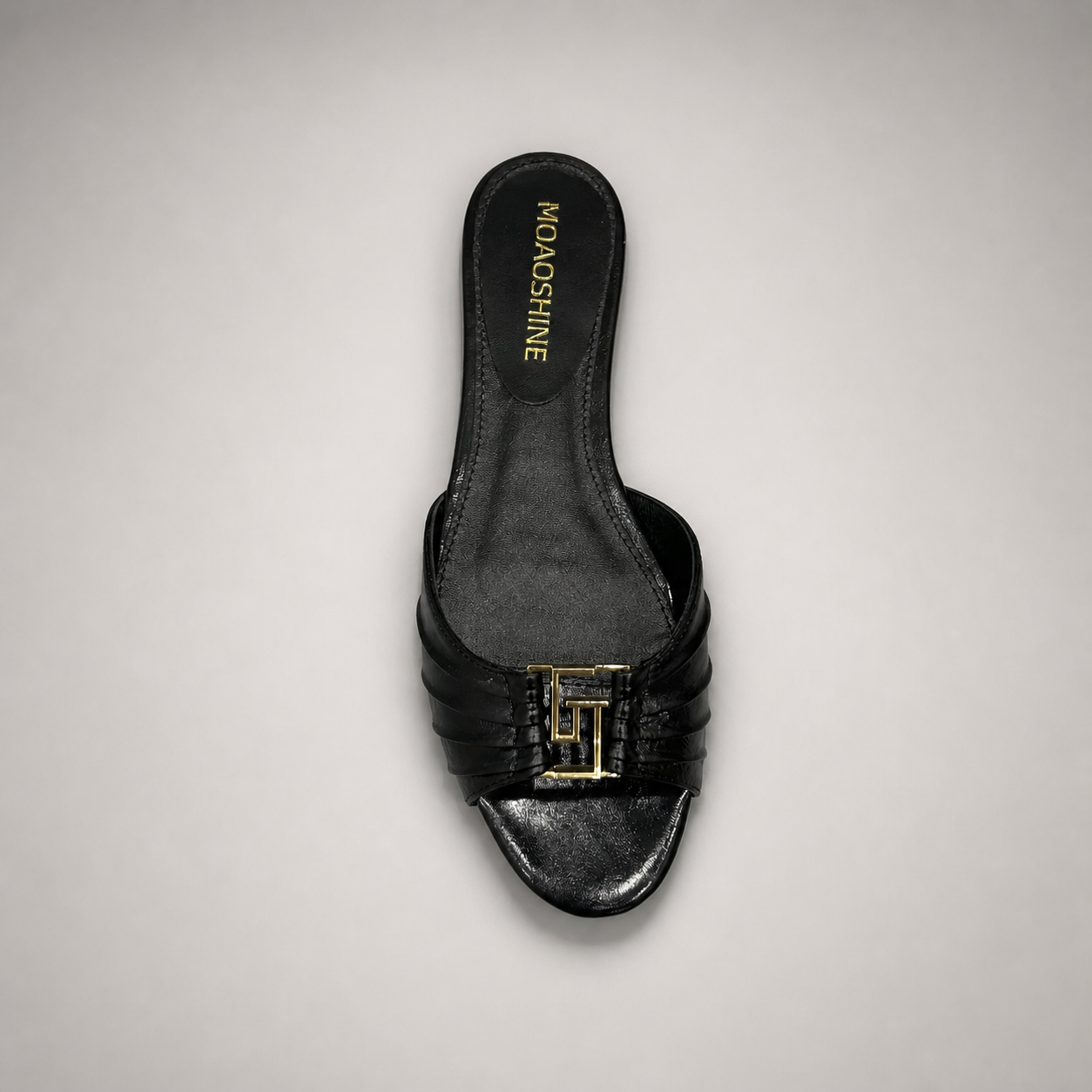 Black slide sandal top view showing a pleated forefoot strap