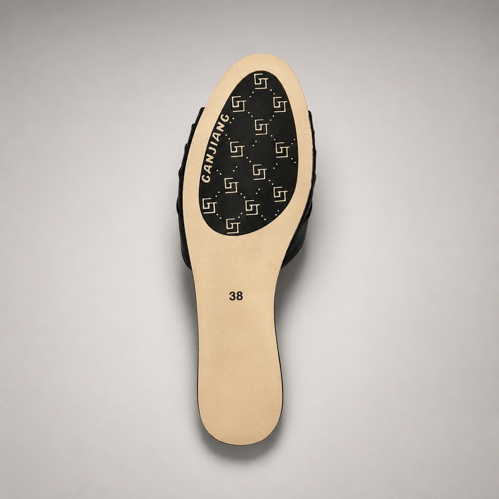 Black slide sandal outsole view showing the cow leather outsole