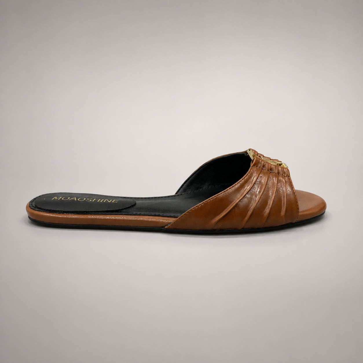 Brown slide sandal side profile showing a braided forefoot strap