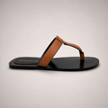 Brown flat sandal side profile showing a flat sole with a toe-loop strap