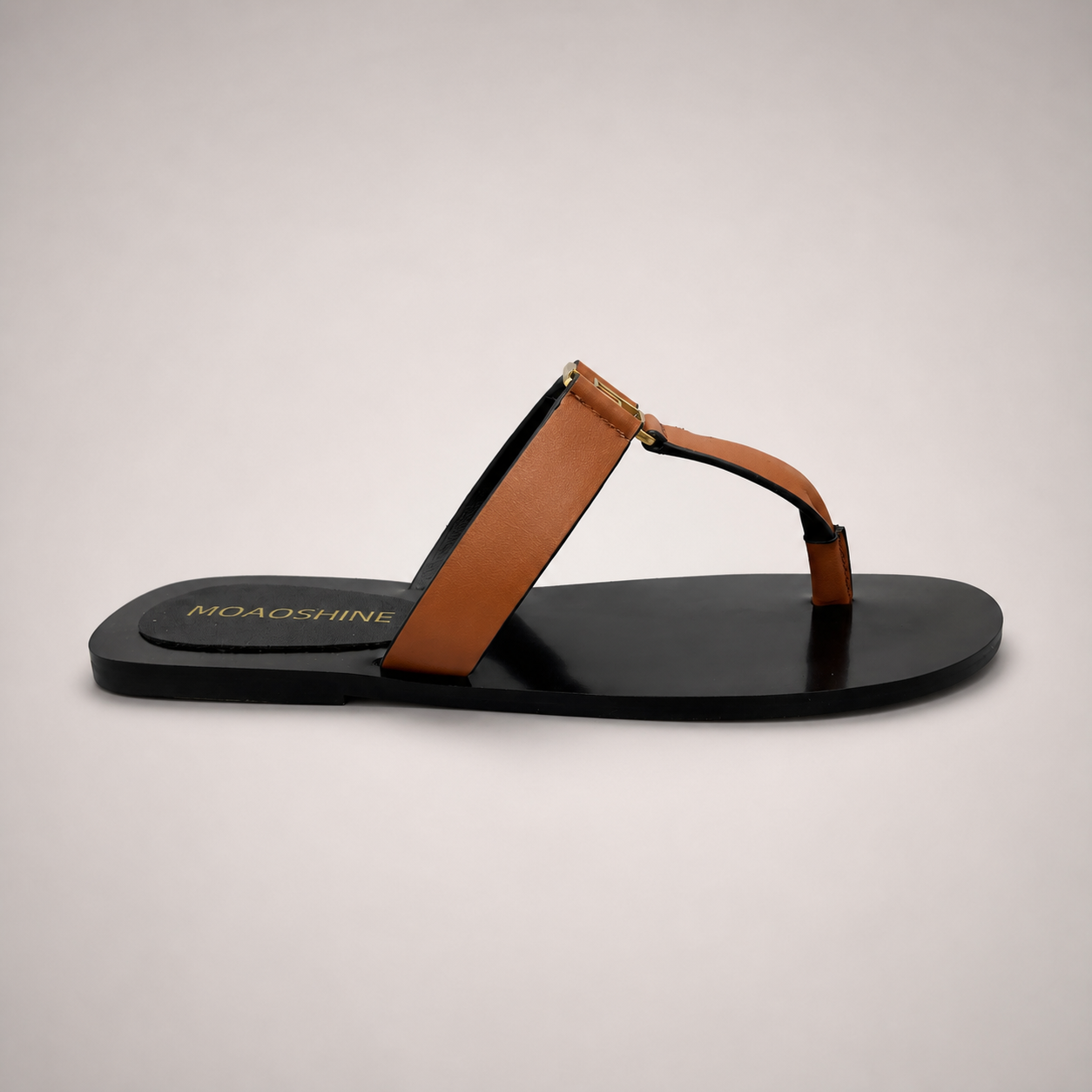 Brown flat sandal side profile showing a flat sole with a toe-loop strap