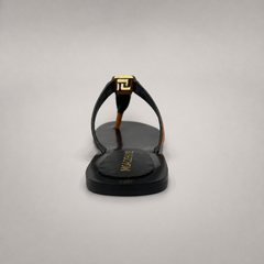 Brown flat sandal rear view showing a flat sole with a toe-loop strap