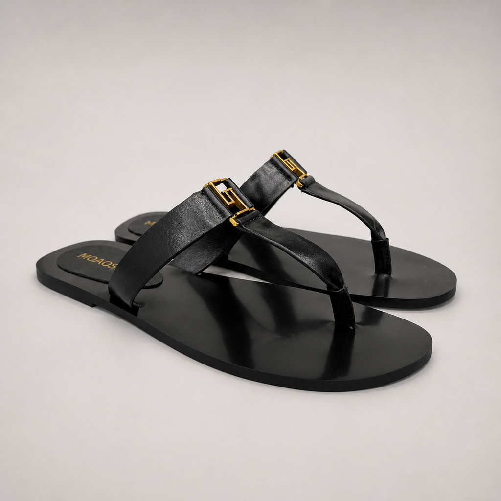 Black flat sandal pair three-quarter view showing a flat sole with a toe-loop strap