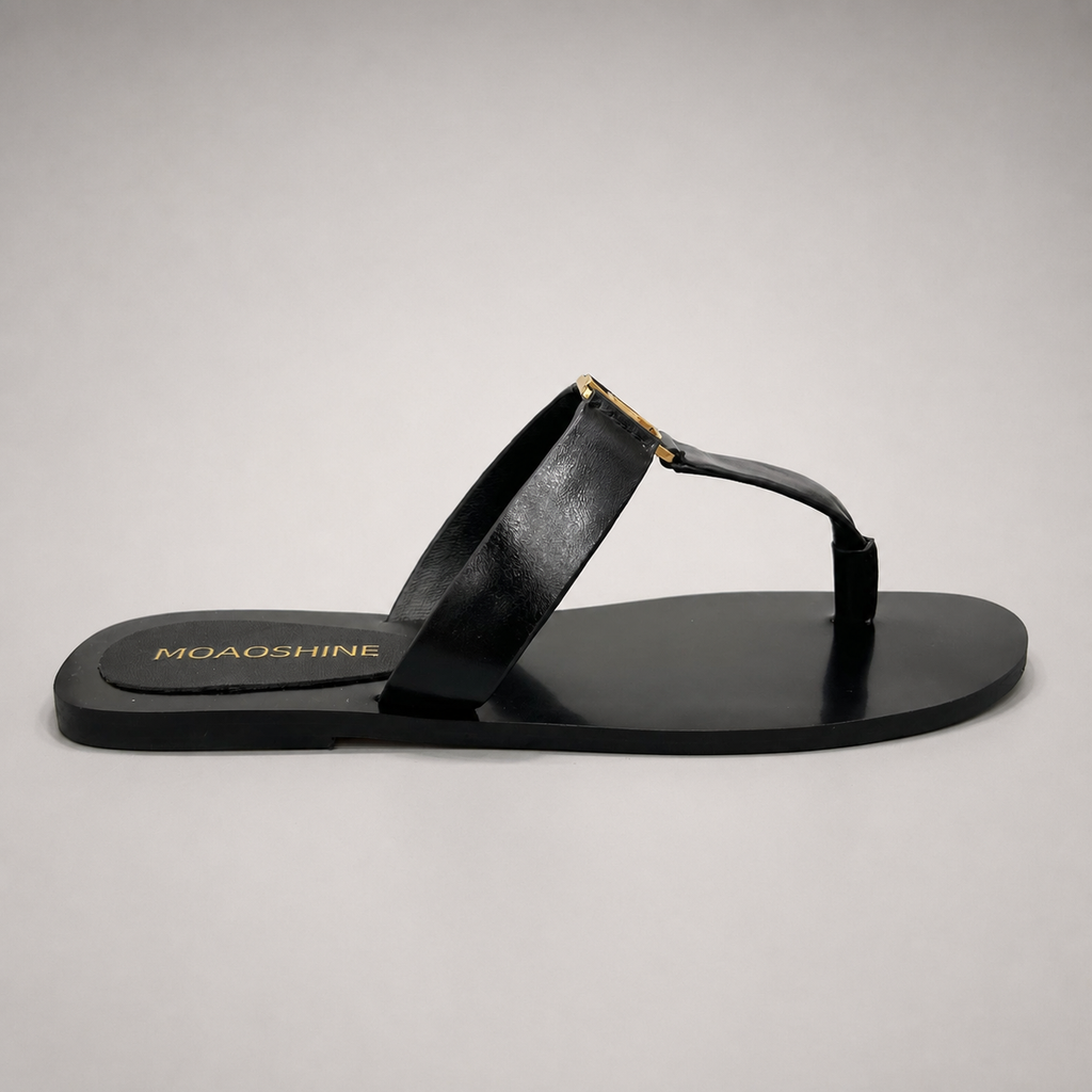 Black flat sandal side profile showing a flat sole with a toe-loop strap
