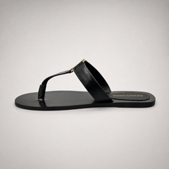 Black flat sandal opposite side profile showing a flat sole with a toe-loop strap