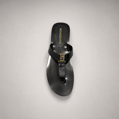 Black flat sandal top view showing a flat sole with a toe-loop strap