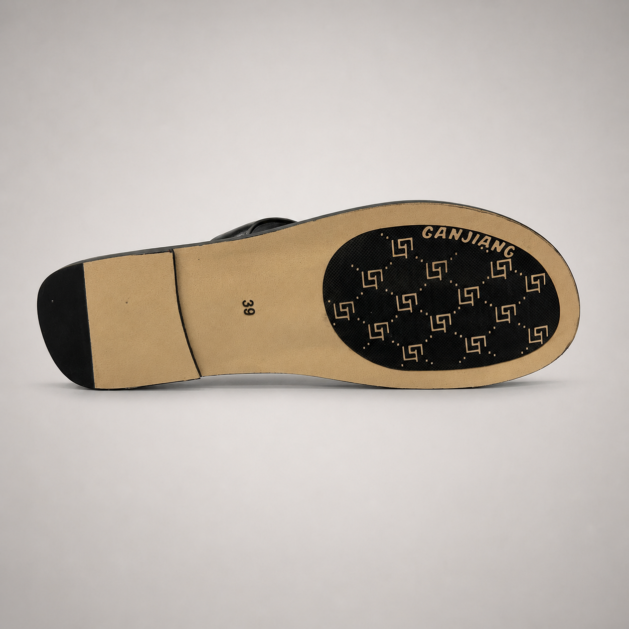 Black flat sandal outsole view showing the cow leather outsole