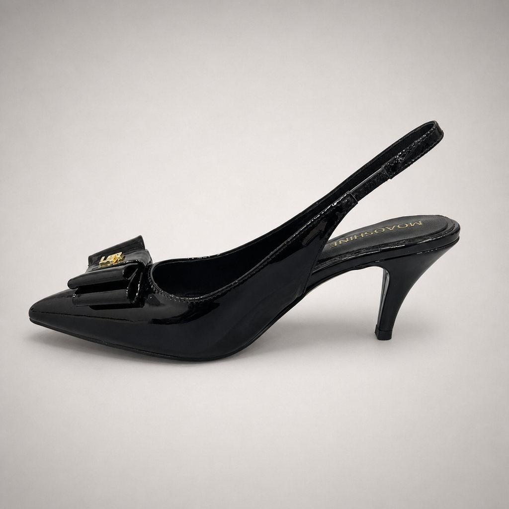 Black slingback pump opposite side profile showing a pointed toe and bow-shaped vamp ornament