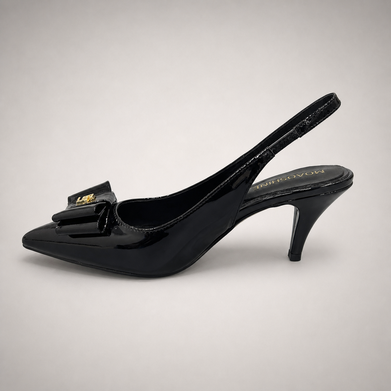 Black slingback pump opposite side profile showing a pointed toe and bow-shaped vamp ornament