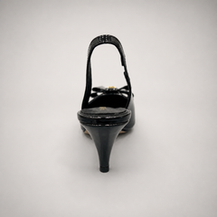 Black slingback pump top view showing a pointed toe and bow-shaped vamp ornament