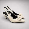 Ivory slingback pump pair three-quarter view showing a pointed toe and bow-shaped vamp ornament